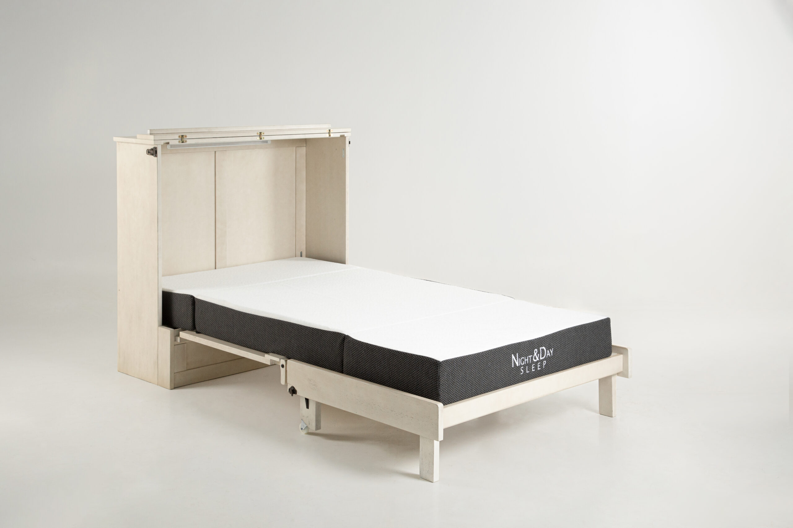 Murphy Express Twin Provence 3 - SDS Cabinet Beds Light wood bed frame with a white mattress and dark fabric sides, set in a minimalist room. (Night&Day Sleep branding visible on the mattress)